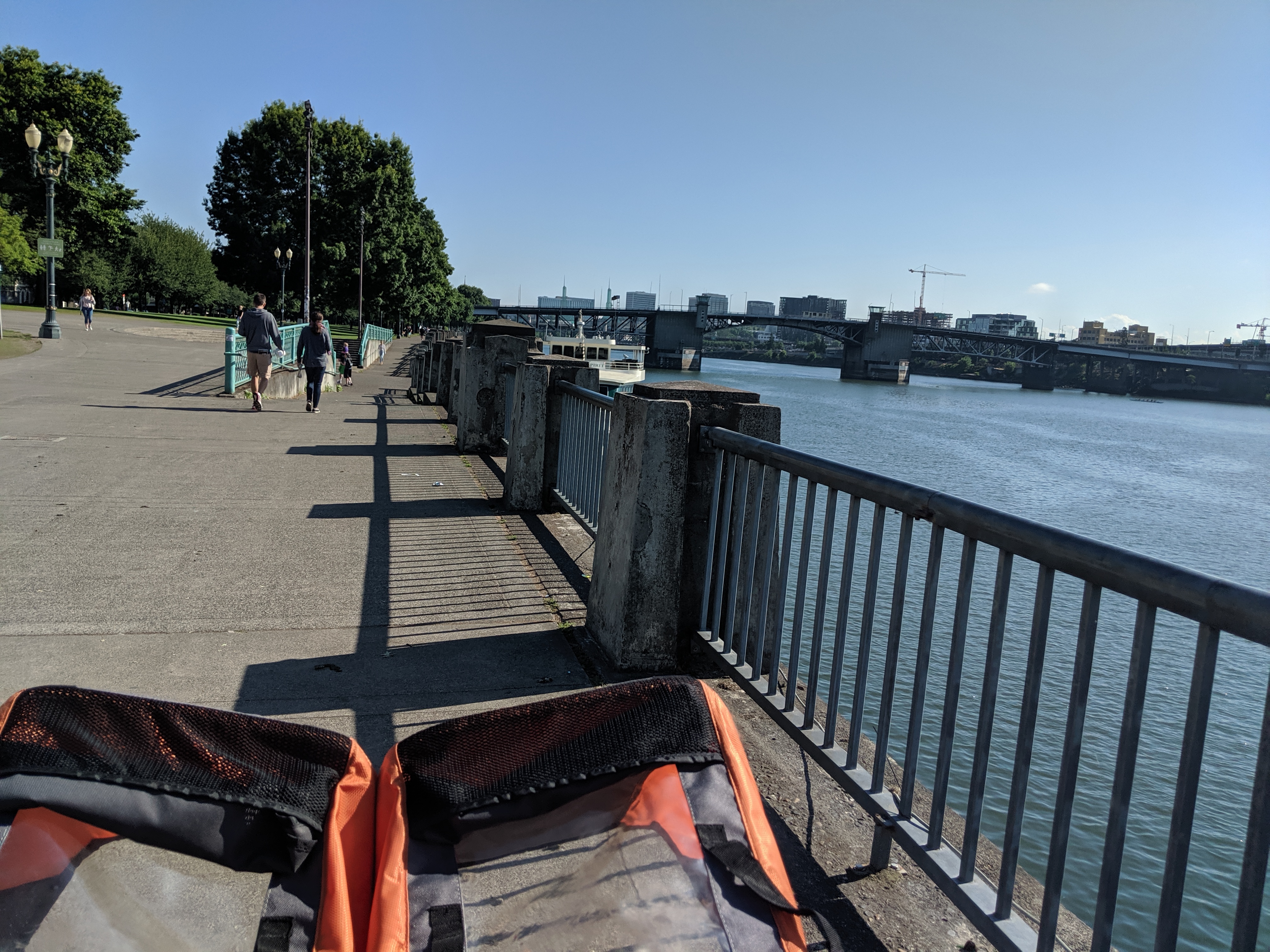 double stroller in the bottom left corner, view of the Burnside Bridge and the Willamette River to the right.